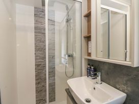 A bathroom with a shower and sink at The Beaumont No 34 New Quay