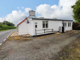 A house with windows and an air conditioning unit at 2 Llainwen Ty Croes