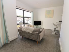 A living room with a sofa and television at Harbour View in Whitehaven