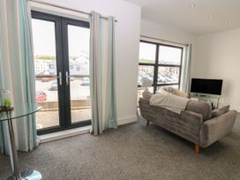 A living room with a sofa and television at Harbour View in Whitehaven