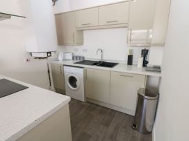 A kitchen with a washing machine and sink at Harbour View in Whitehaven