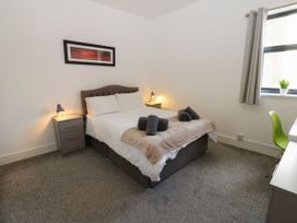 A bedroom with a bed and nightstand at Harbour View in Whitehaven