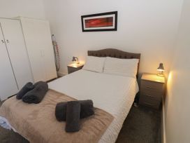 A bedroom with a bed and nightstand at Harbour View Whitehaven