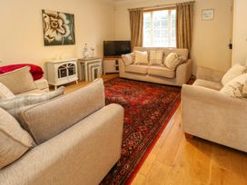 A living room with sofas and a coffee table at Fairways House in Weymouth
