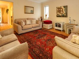 A living room with furniture and decor at Fairways House in Weymouth
