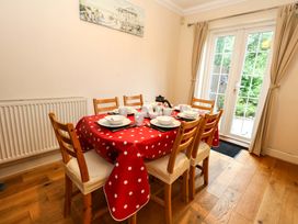 A dining room with a table set for meals at Fairways House Weymouth