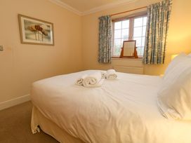 A bedroom with a bed and towels on it at Fairways House in Weymouth