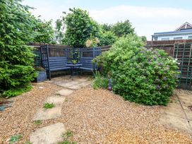 A garden with gravel path and seating area at Fairways House Weymouth