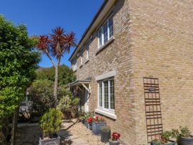 A house with plants and flower pots at Fairways House in Weymouth