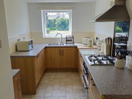 A kitchen with a sink and stove at 13 Seafield Road