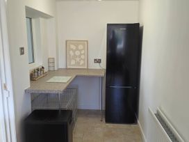 A kitchen with a refrigerator and counter space at 13 Seafield Road