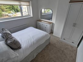 A bedroom with a bed and dresser at 13 Seafield Road