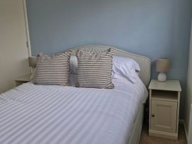 A bedroom with a bed and nightstand at 13 Seafield Road