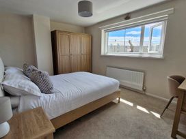 A bedroom with a bed and wardrobe at 13 Seafield Road