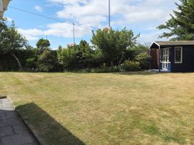 A garden with a shed and trees at 13 Seafield Road 