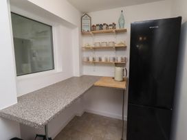 A kitchen with a countertop and a refrigerator at Bari House in Seahouses