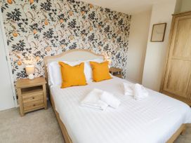 A bedroom with a bed and nightstand at Bari House in Seahouses
