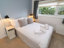 A bedroom with a bed and bedside table at Bari House in Seahouses