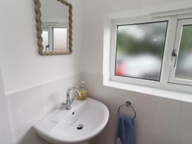 A bathroom with a sink and mirror at Bari House in Seahouses