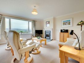 A living room with furniture and large windows at The Granary in Alnwick