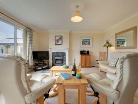A living room with a television and coffee table at The Granary in Alnwick