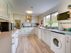A kitchen with appliances and cabinets at The Granary in Alnwick