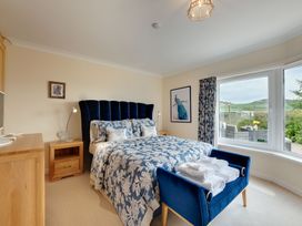 A bedroom with a bed and window at The Granary in Alnwick