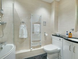 A bathroom with a shower, toilet, and wash basin at The Granary in Alnwick