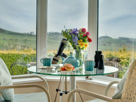A conservatory with a table set for tea at The Granary in Alnwick