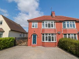 A house with a driveway and hedge at 60 Muston Road in Filey