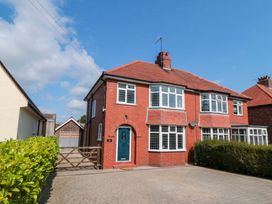 A house with a driveway and garden at 60 Muston Road Filey