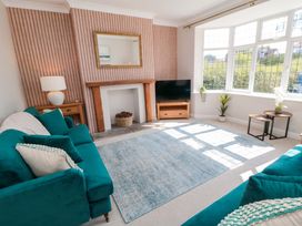 A living room with a television and a sofa at 60 Muston Road in Filey