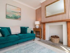 A living room with a sofa and a table at 60 Muston Road in Filey