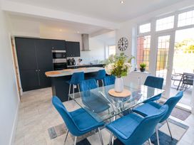 A dining room with a table and chairs at 60 Muston Road in Filey