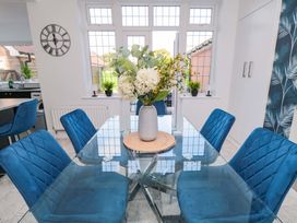 A dining room with a table and chairs at 60 Muston Road in Filey