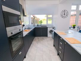 A kitchen with modern appliances and a window at 60 Muston Road in Filey