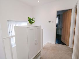 A hallway with a white cabinet and a plant at 60 Muston Road in Filey