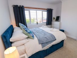 A bedroom with a bed and window at 60 Muston Road in Filey