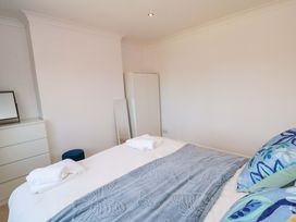A bedroom with a bed and wardrobe at 60 Muston Road in Filey
