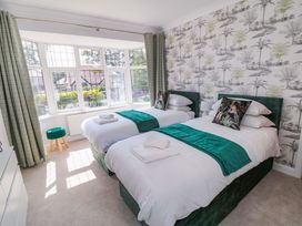 A bedroom with two beds and a window at 60 Muston Road in Filey