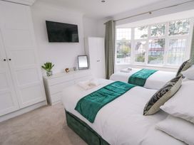 A bedroom with two beds and a television at 60 Muston Road in Filey