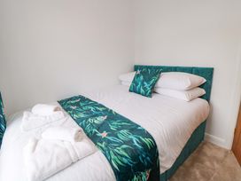 A bedroom with a bed and towels at 60 Muston Road, Filey