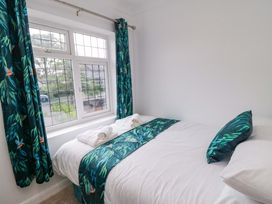 A bedroom with a bed and window at 60 Muston Road in Filey