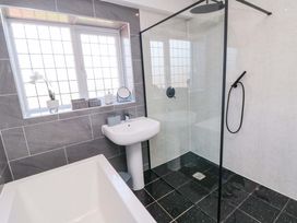 A bathroom with a shower, sink, and bathtub at 60 Muston Road, Filey