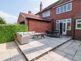 A garden with outdoor sofa and dining table at Sea's The Day in Filey