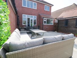 An outdoor seating area with a sofa and table at Sea's The Day in Filey