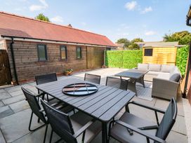 A patio area with seating and plants at Sea's The Day in Filey