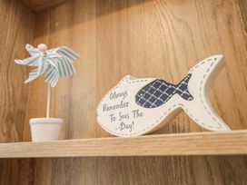 A pinwheel and decorative fish on a shelf at Kelly's Retreat in Scarborough