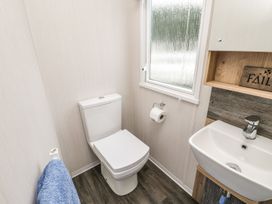 A bathroom with a toilet and sink at Kelly's Retreat in Scarborough