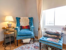 A reading nook with a chair and table at Seacroft in Combe Martin